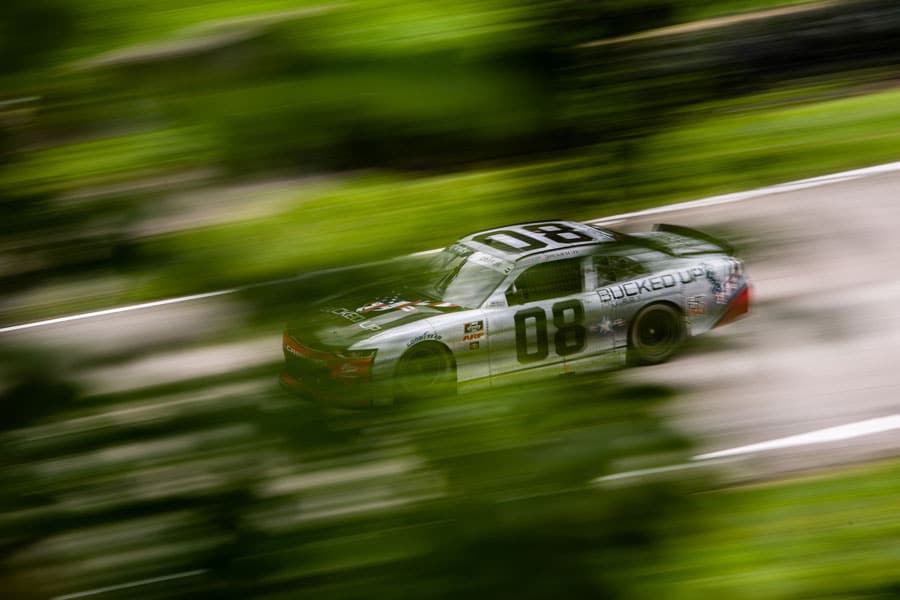 Joe Graf Jr., No. 08 Bucked Up Energy Chevrolet Camaro in gray on track behind green