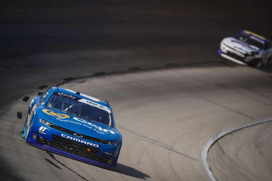 Turquoise blue car racing on track