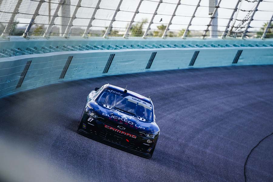 Black race car racing on tract