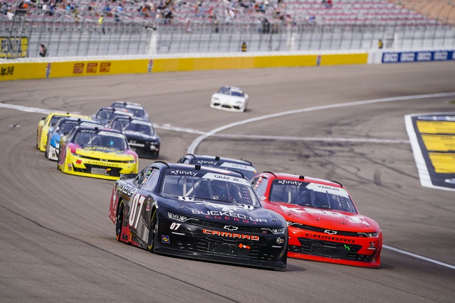 Several race cars racing on a race track